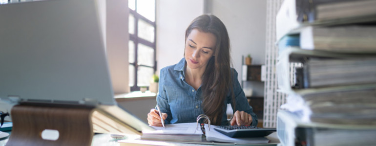 A Professional Bookkeeper working at a private business on their books